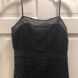 Parker. Black cocktail dress. Sparkle beading. Sheer details.